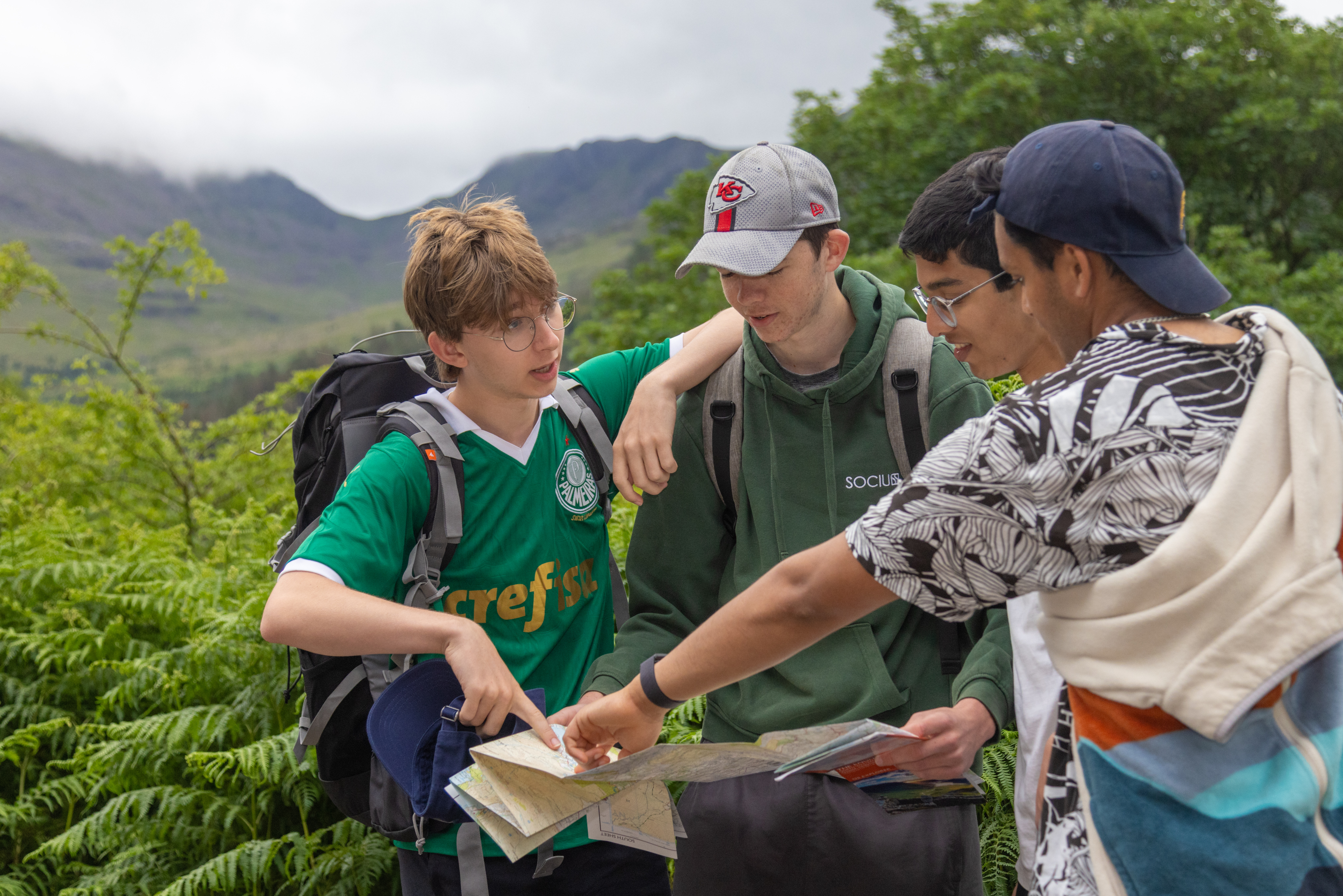 Photo of four young boys discussing a hand-held map at Wild Ennerdale