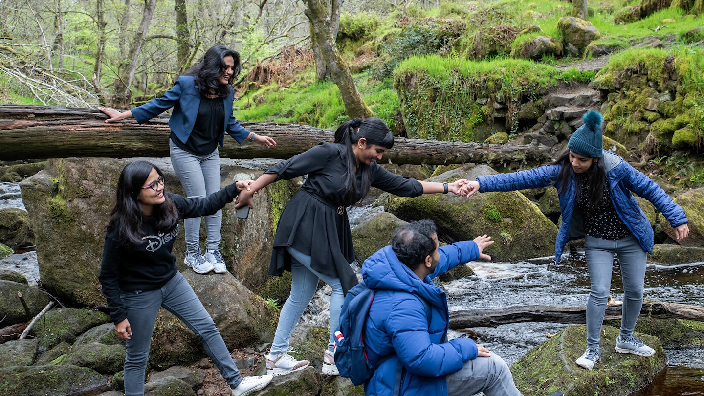 Family enjoying stepping stones in peak district