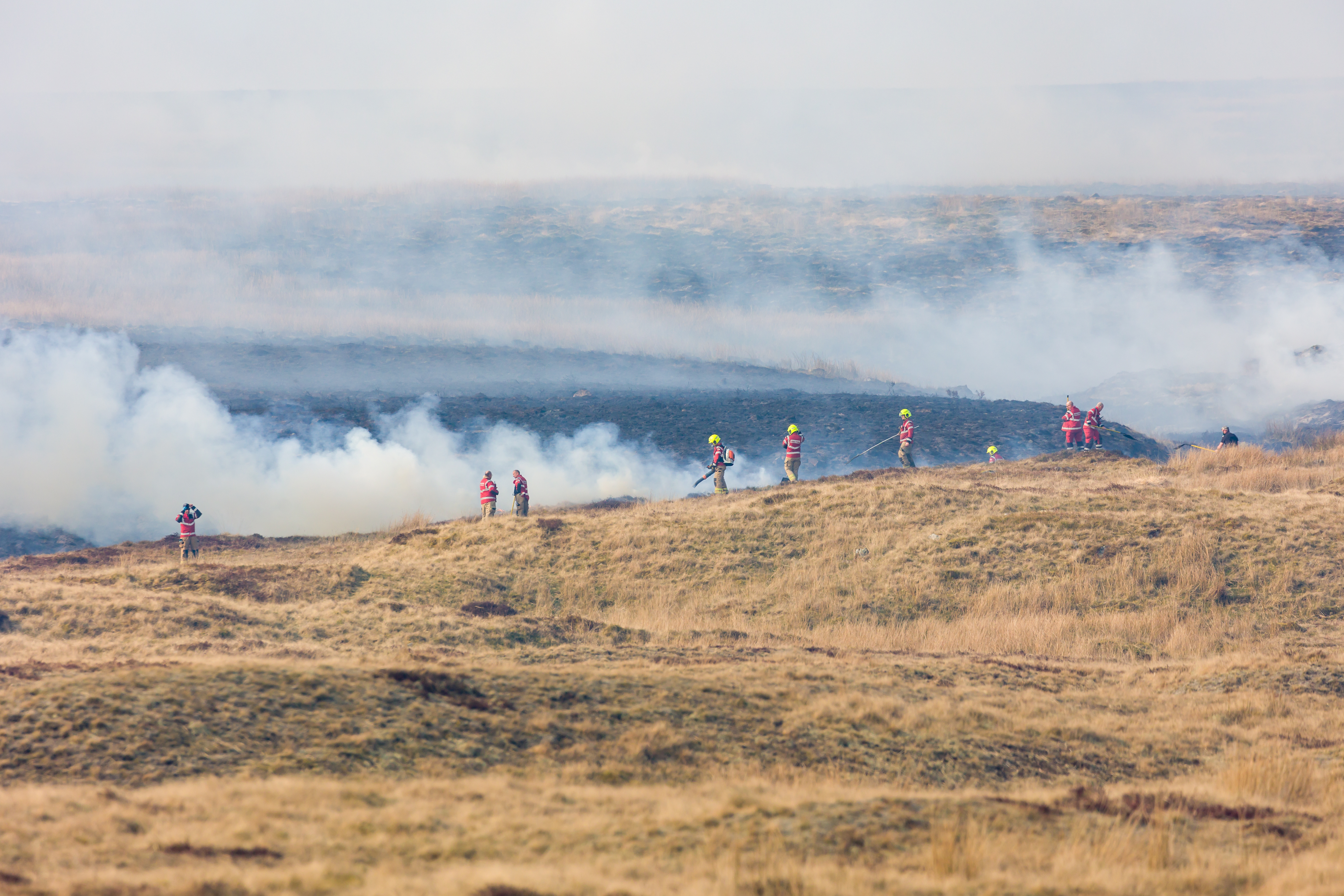 Fire fighters dealing with a large grassfire on an upland moors in Wales