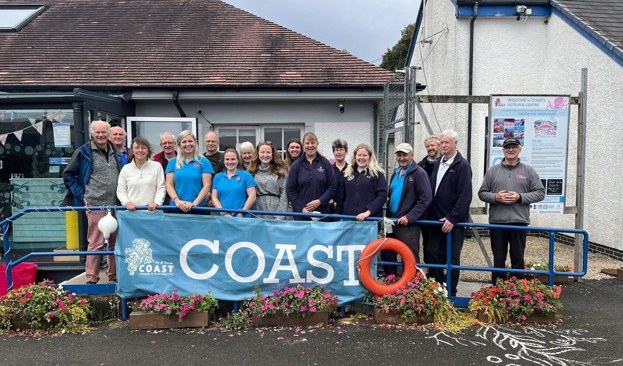People stood in front of a COAST banner