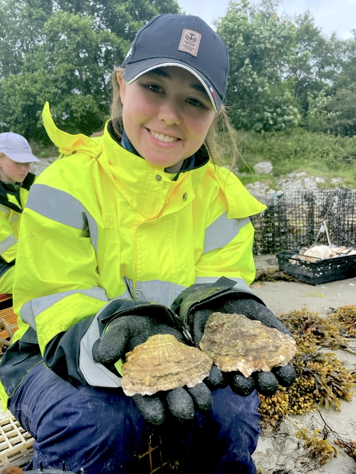 Female intern with oyster shells in her hands
