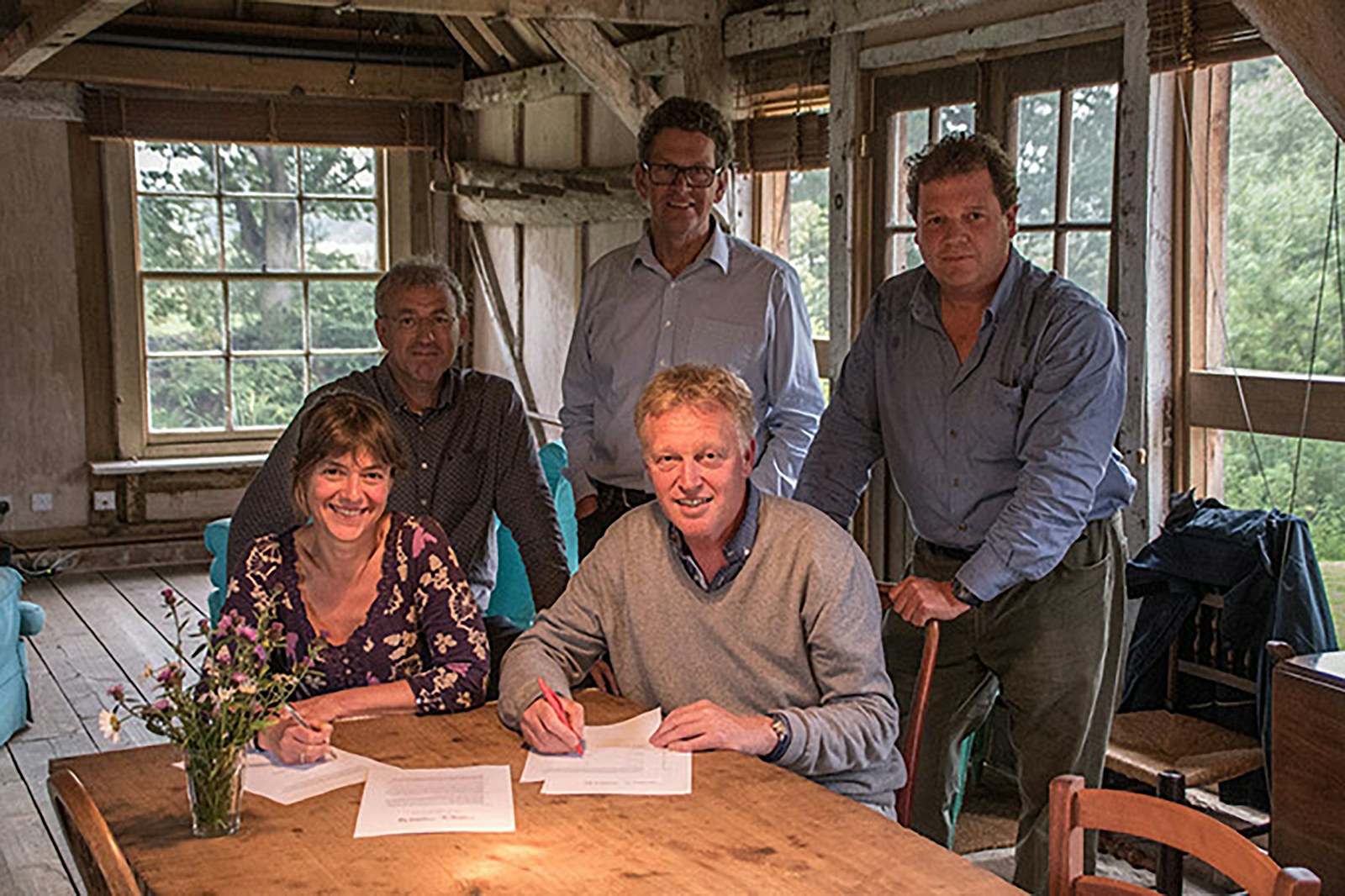 Frank Schepers and Rebecca Wrigley signing a document