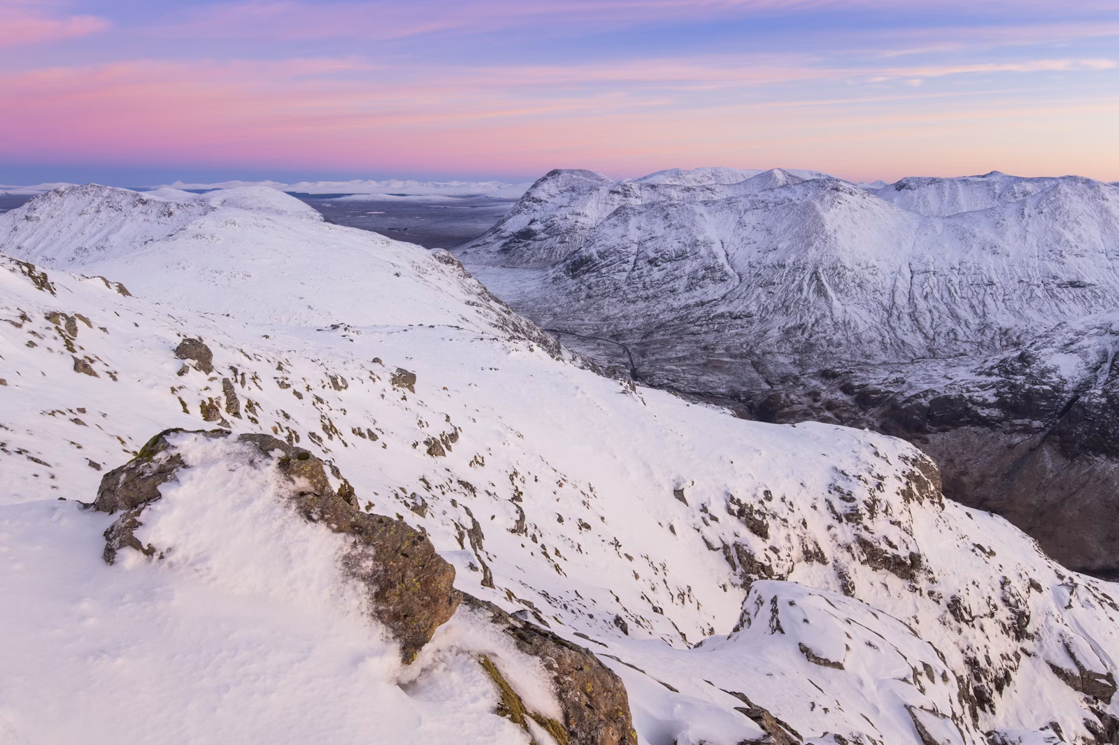 View looking south east from Am Bodach towards Stob nan Cabar and Buachaille Etive Beag in winter, Glen Coe, Lochaber, Scotland.