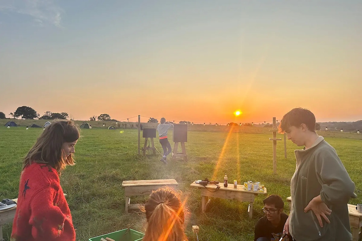 Young people around a campfire at Heal Somerset