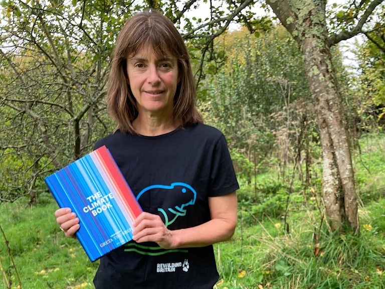 Rebecca Wrigley holding The Climate Book