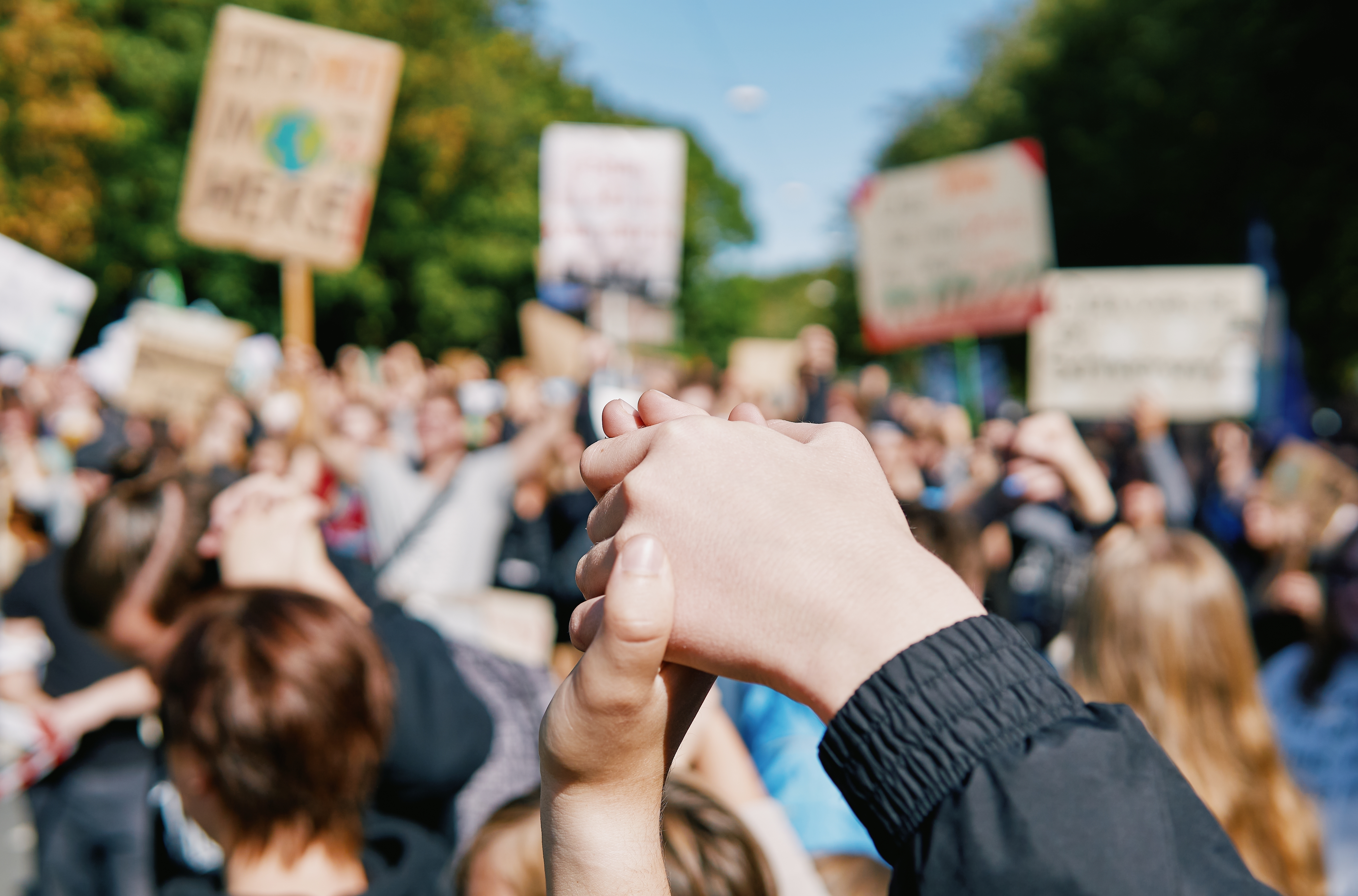 Climate protest showing hands and banners