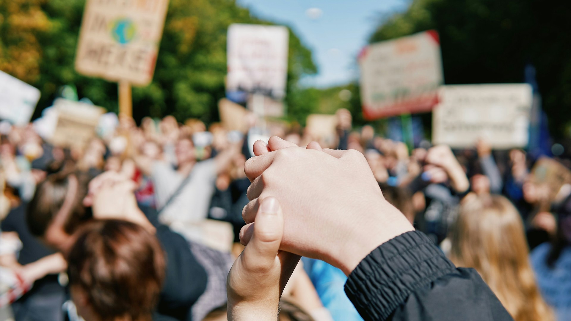 Close up of clasped hands at climate protest