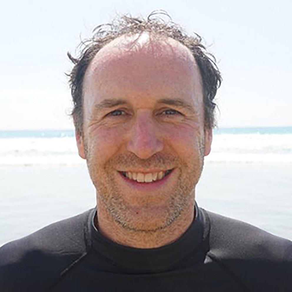 Close-up portrait of David Tudor with the ocean in the background