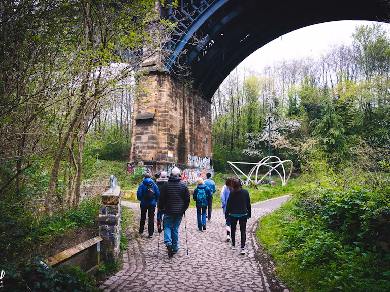 People walking under a viaduct in Ouseburn, Newcastle