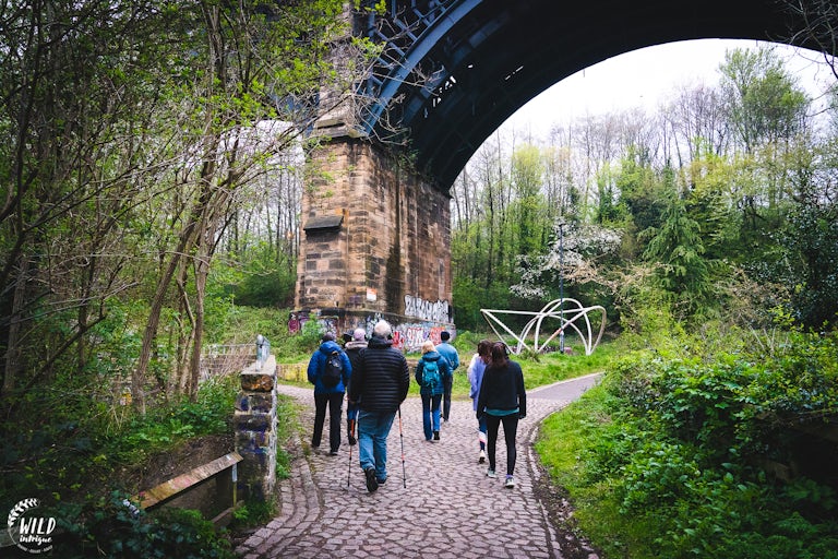 People walking under a viaduct in Ouseburn, Newcastle