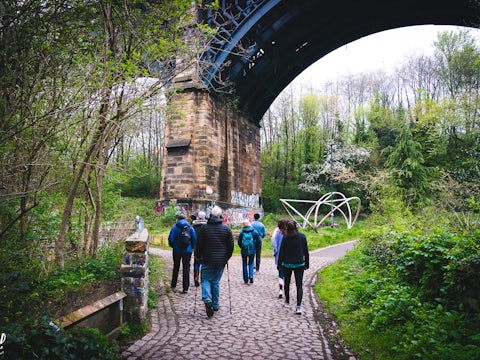 People walking under a viaduct in Ouseburn, Newcastle