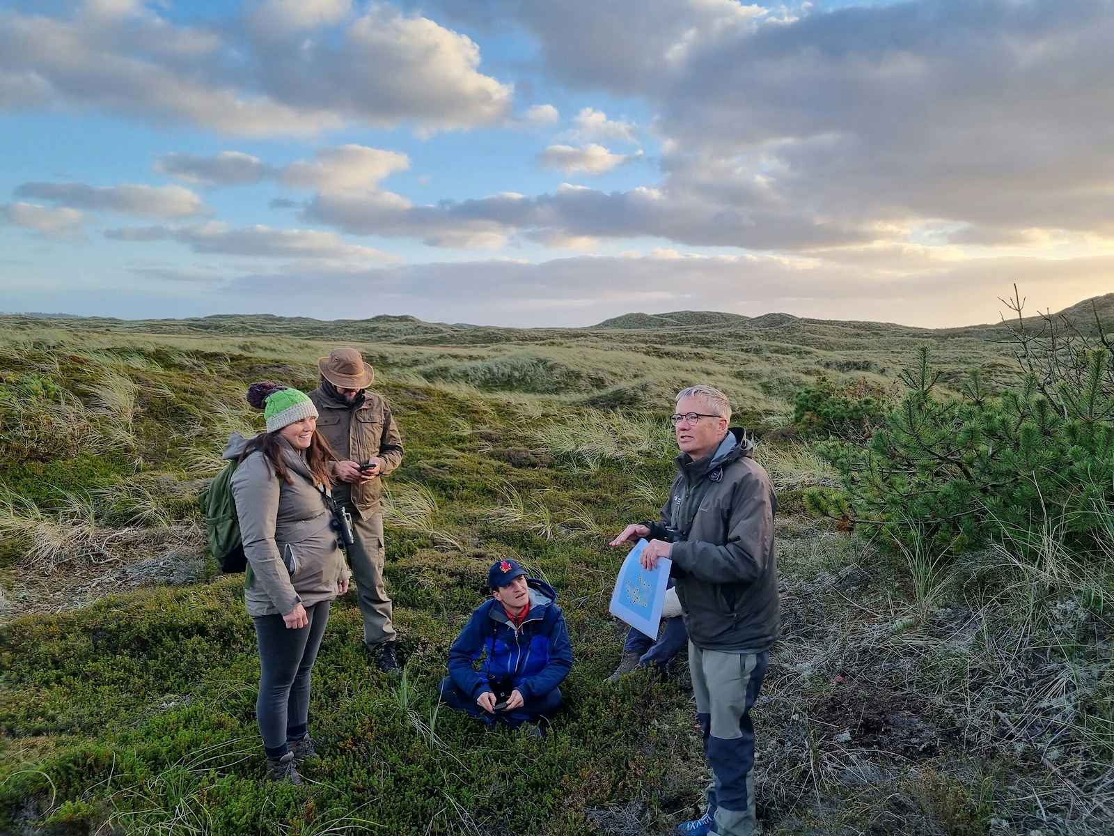 People learning from each other on sand dunes in Denmark on a field trip