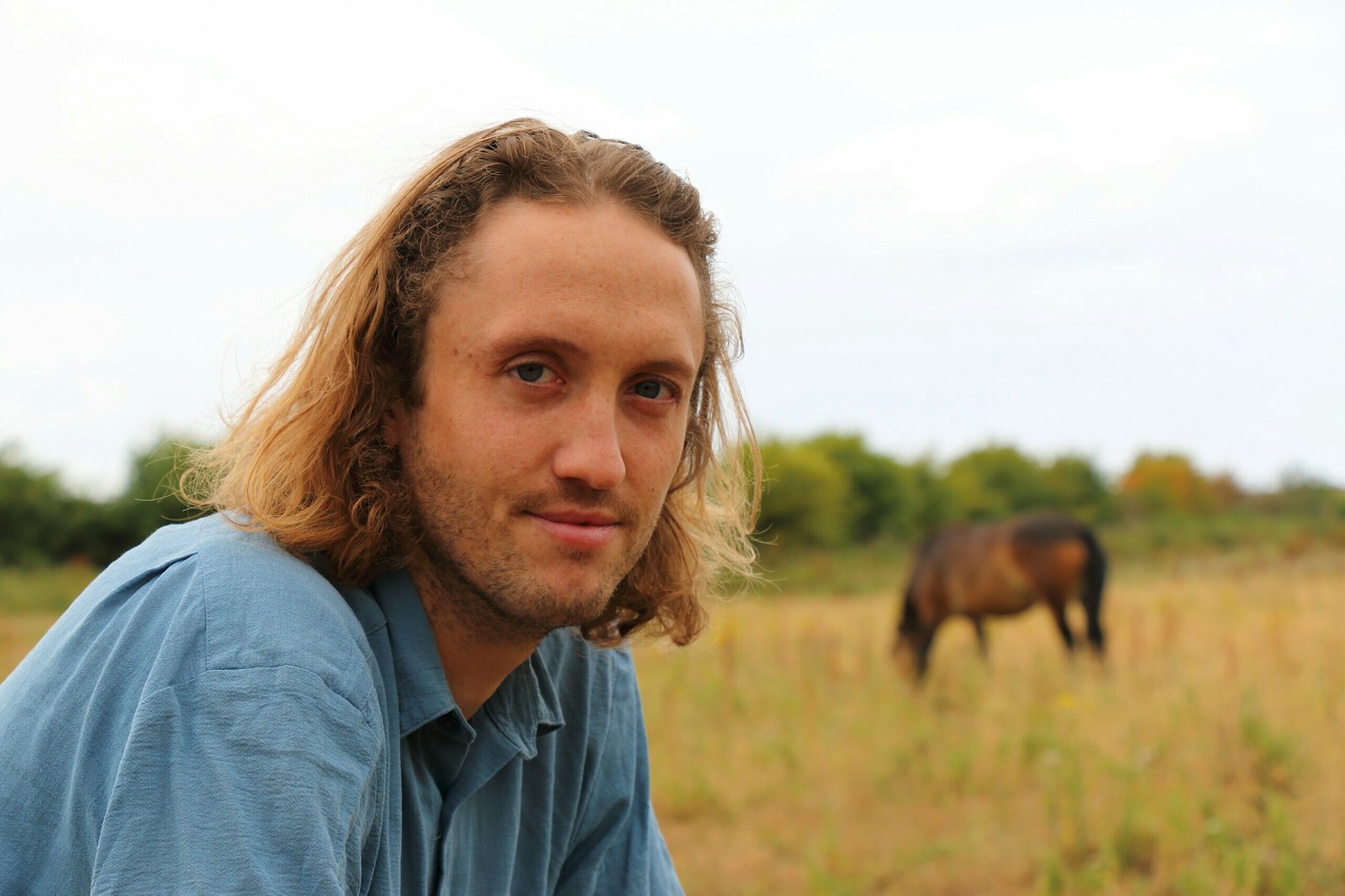 Dominic Buscall with a pony in the background at Wild Ken Hill