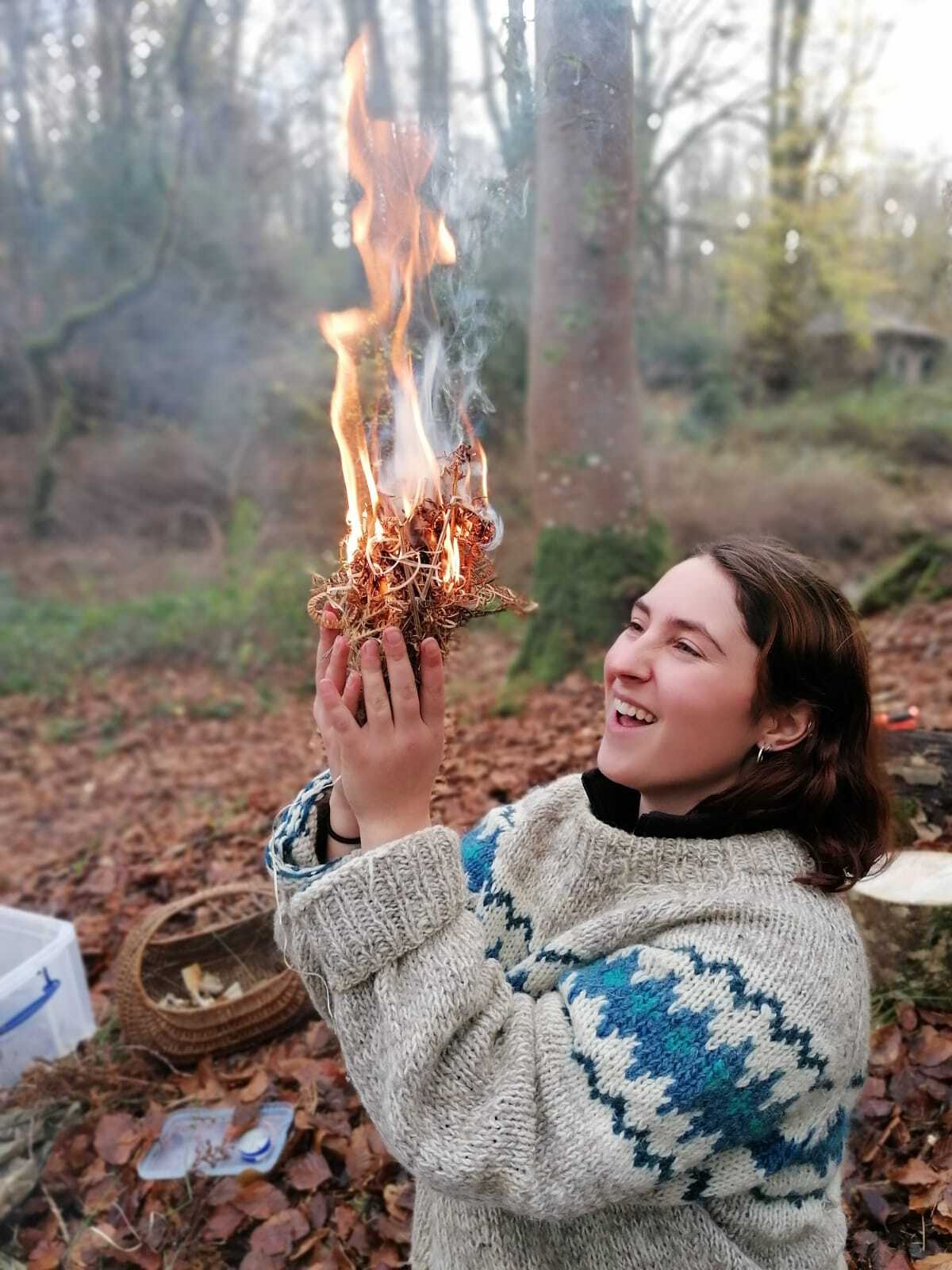 Ella Davies learns how to make fire with flint and steel during a bushcraft session during her rangership at the Penpont Project.