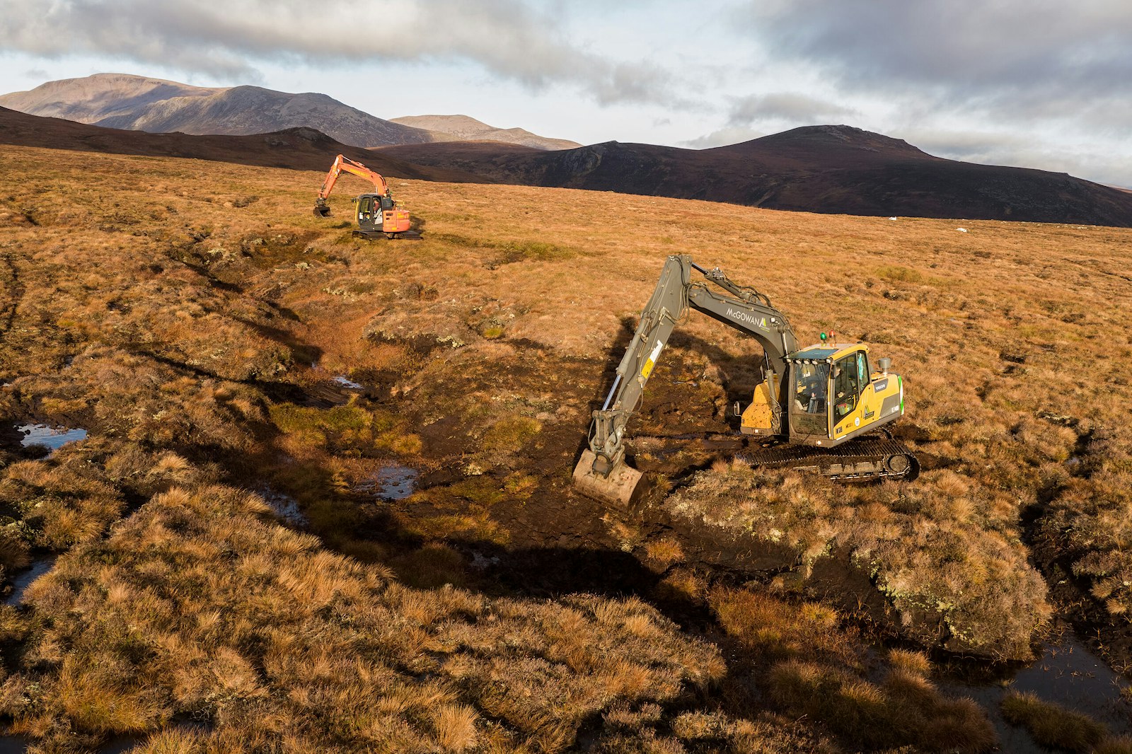 Two excavators from McGowan Ltd working on restoring peatland at Mar Lodge estate.