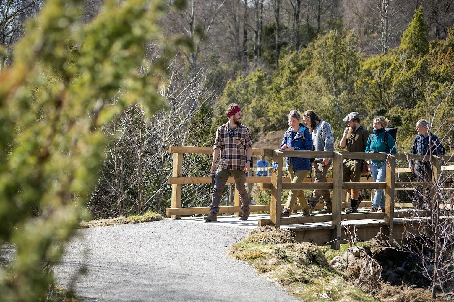 A tour guide gives a walking tour the Dundreggan Rewilding Centre
