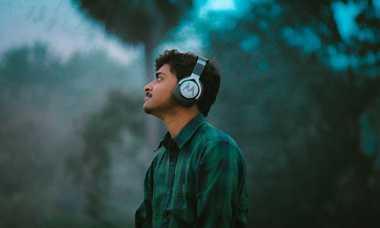 Man wearing headphones in nature