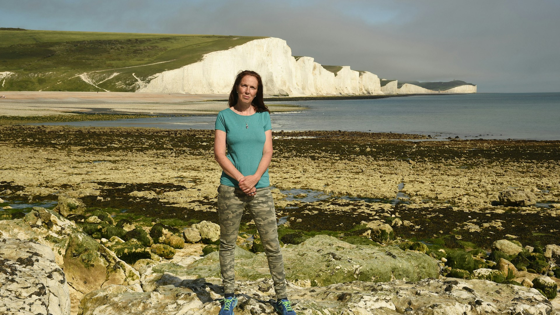 Henri Brocklebank, Director of Conservation, Sussex Wildlife Trust, standing on a beach in Sussex