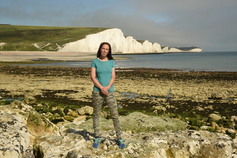 Henri Brocklebank, Director of Conservation, Sussex Wildlife Trust, standing on a beach in Sussex