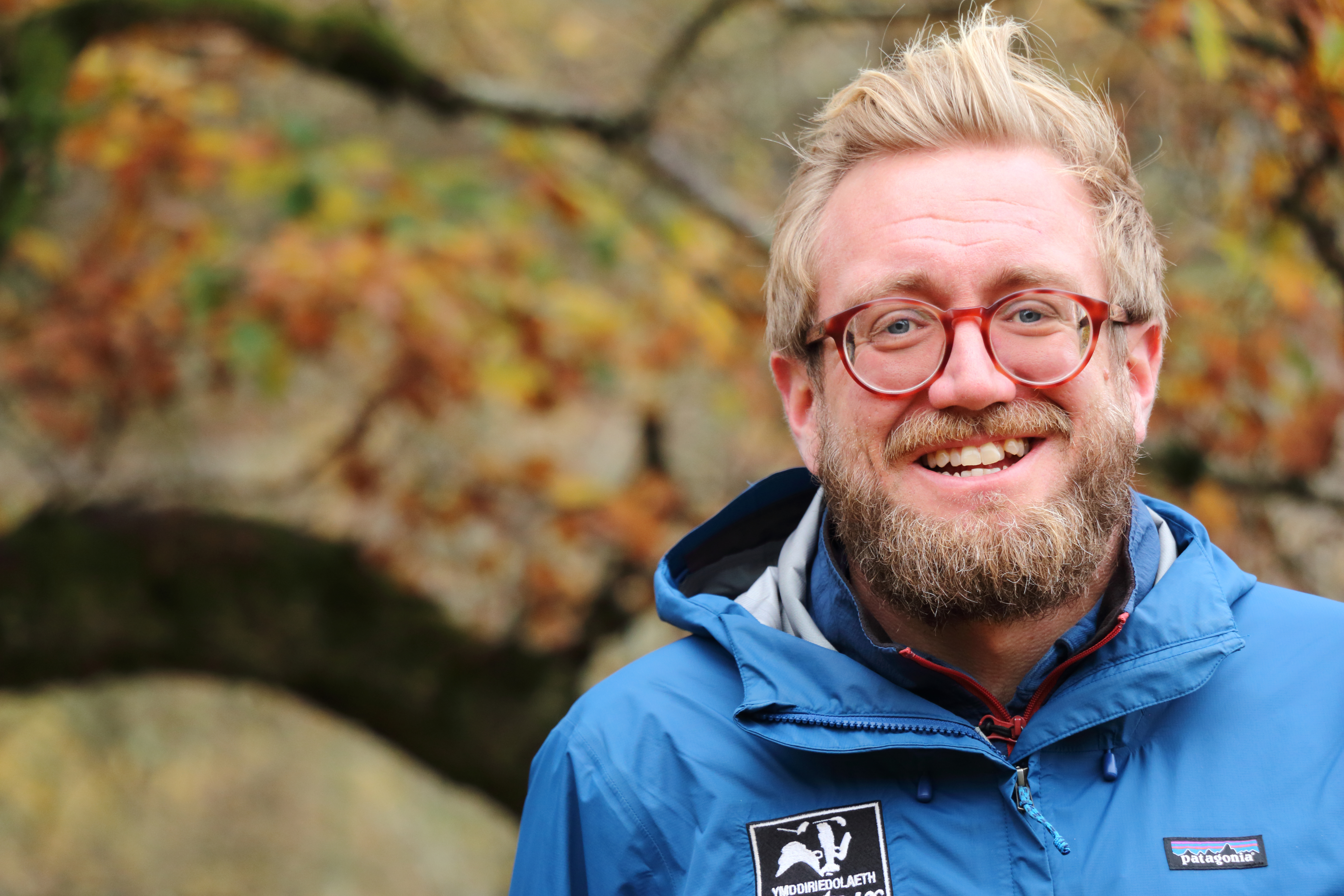 James Hitchcock, CEO of Radnorshire Wildlife Trust, standing in woodland