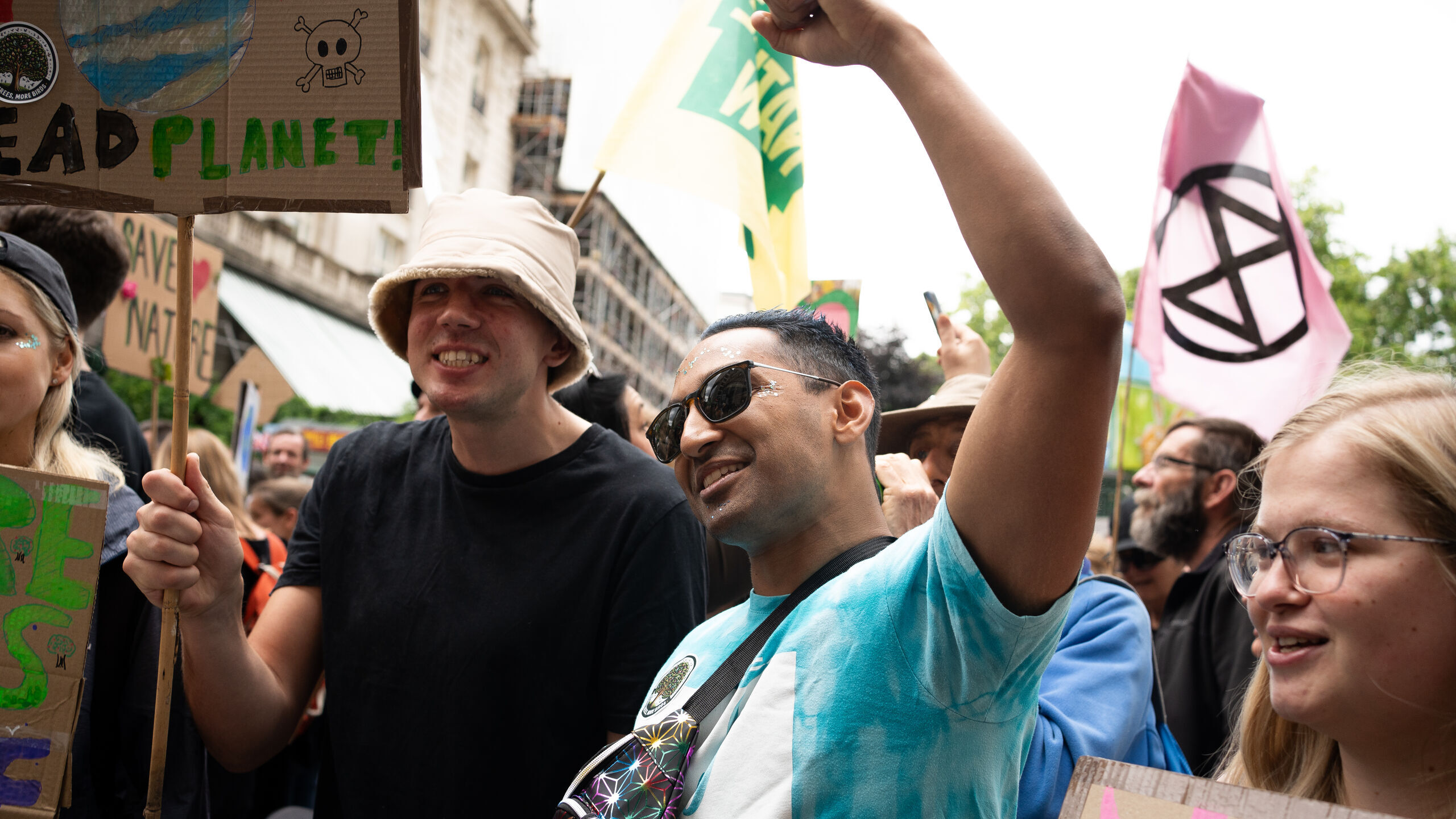 People with flags and placards at a march in London, England