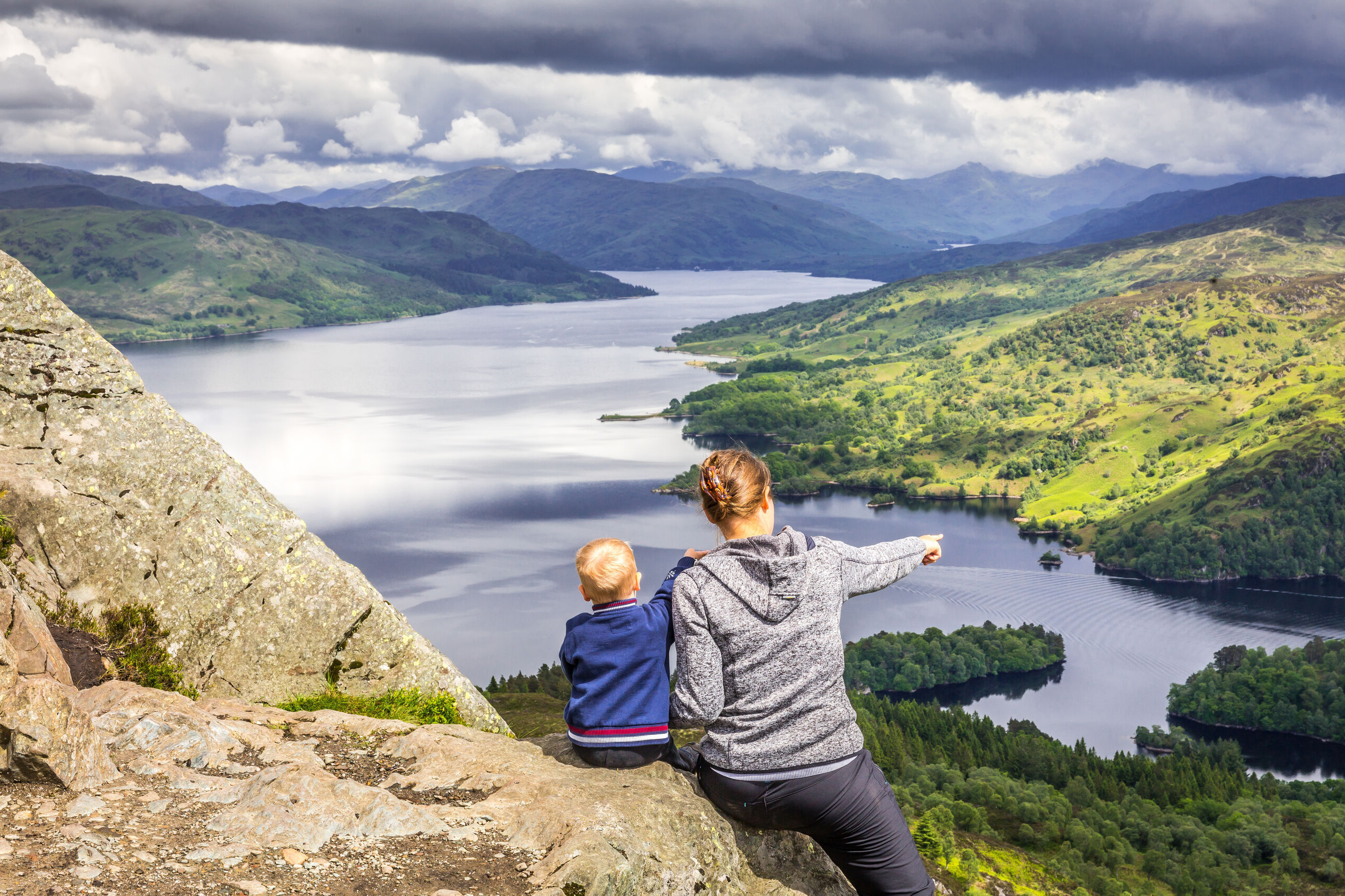 Mom and boy watching Loch Katrine, Scotland.