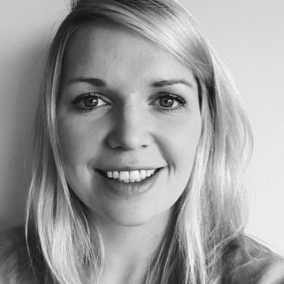 Black and white headshot of Áine Purcell-Milton