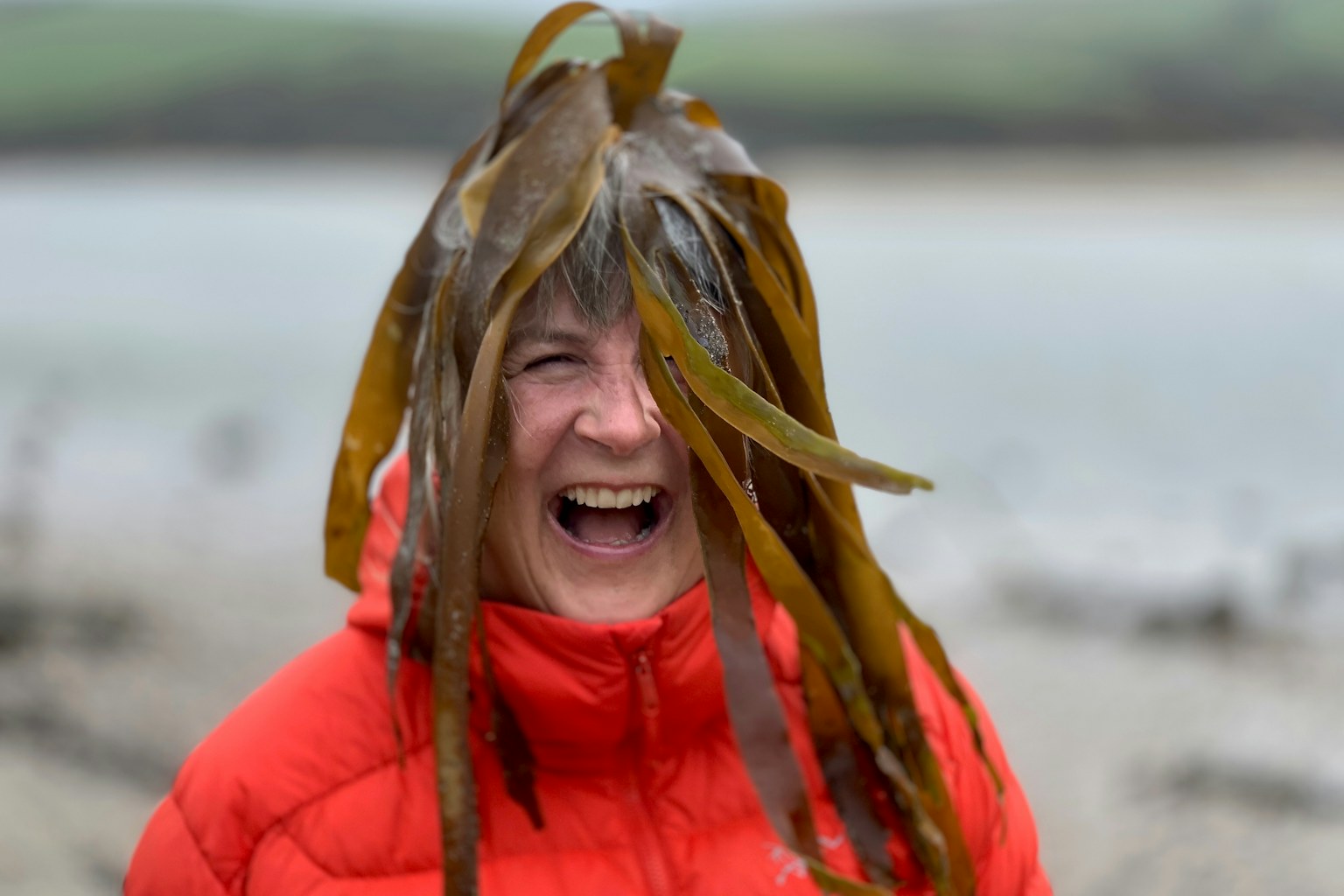 Wildlife filmmaker Sarah Cunliffe on a beach with kelp on her head