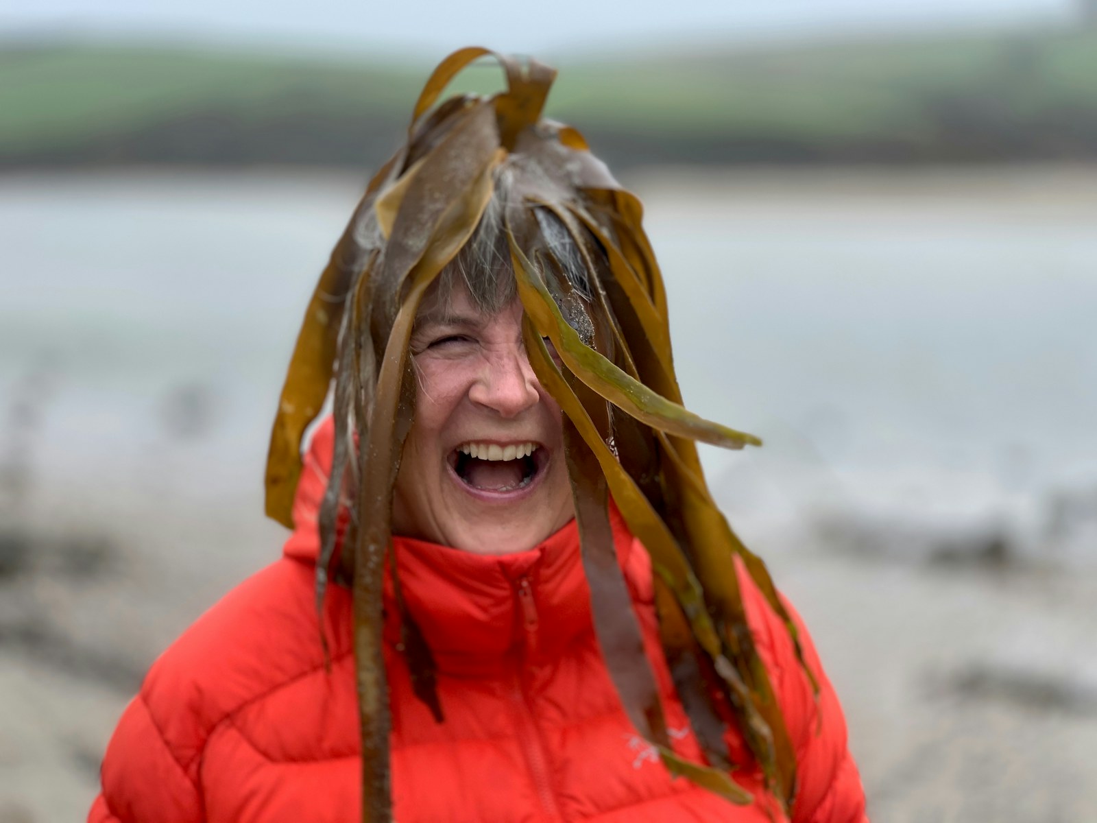 Wildlife filmmaker Sarah Cunliffe on a beach with kelp on her head