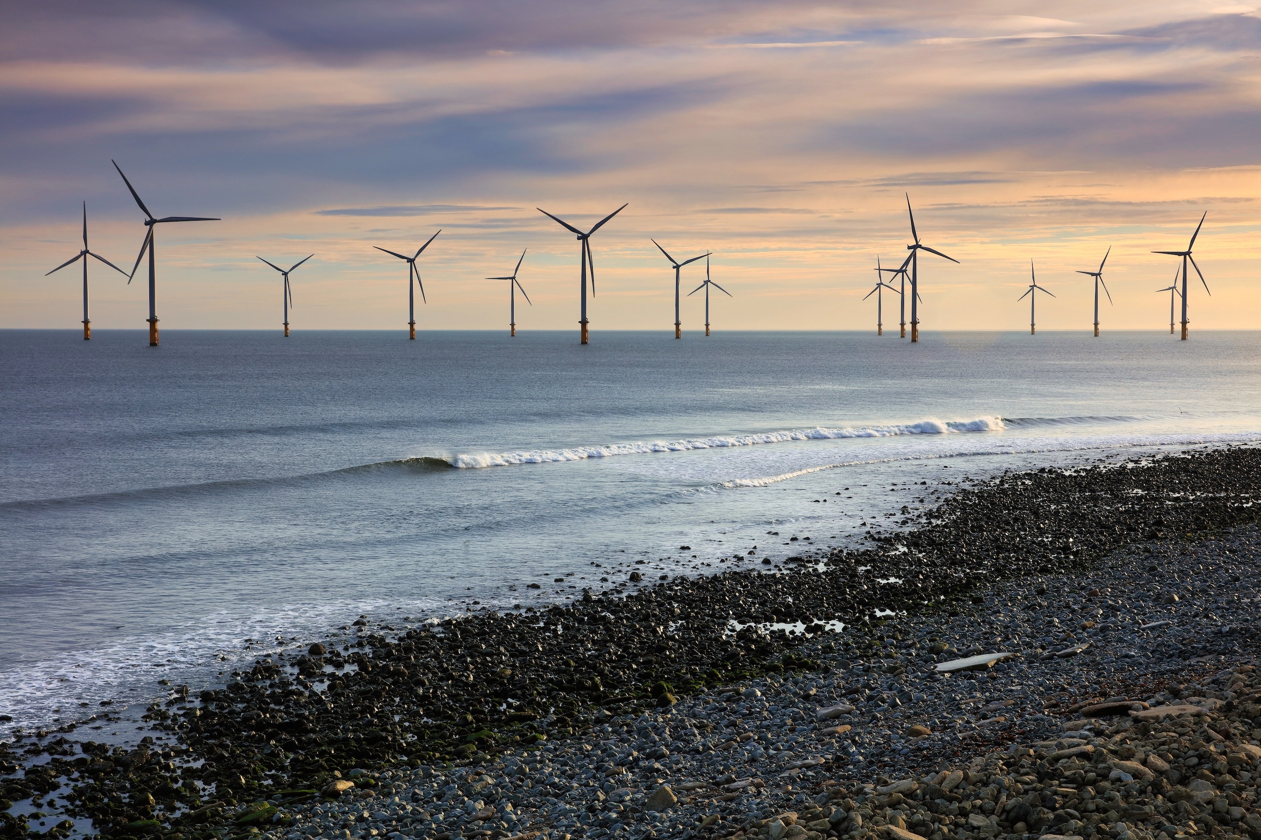 Large wind farm off the coast of Redcar, North Yorkshire, England, UK, at sunset